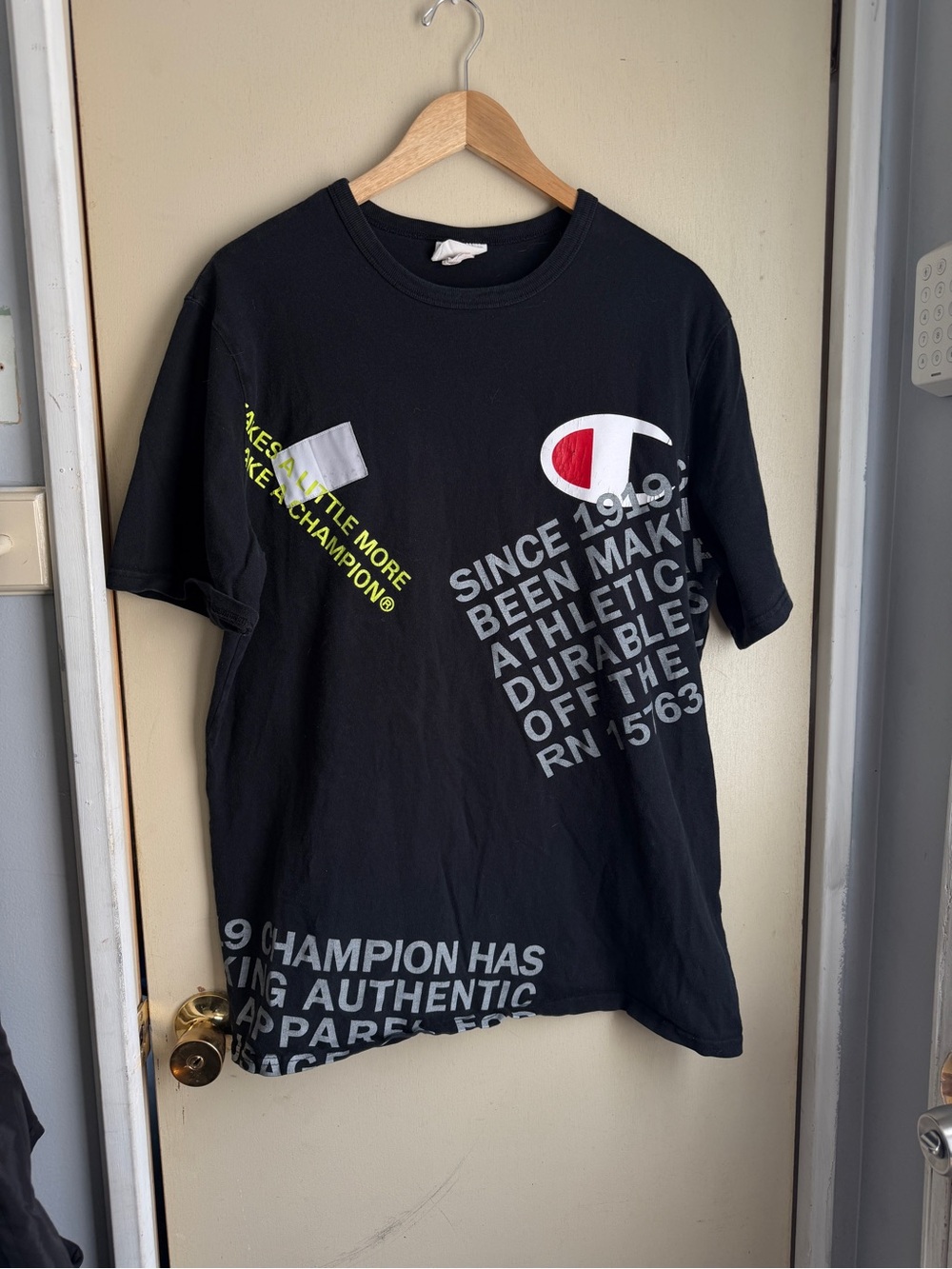 Champion Black Short Sleeve Graphic Logo Tee with White & Red Emblem